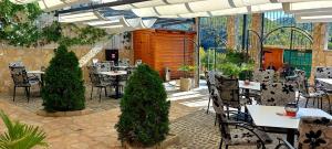ein Restaurant mit Tischen und Stühlen in einem Innenhof in der Unterkunft Hotel Blagaj Mostar in Blagaj