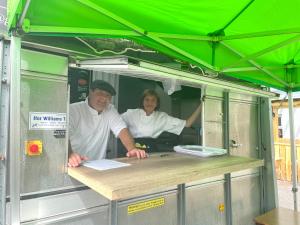 a man and a woman standing in a food truck at Atlantic Apartotel in Bundoran