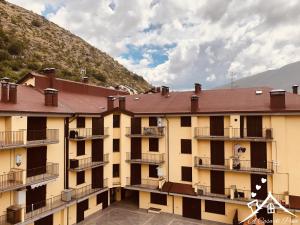 a building with balconies and a mountain in the background at A Casa di Pina in Collimento