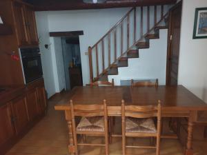 une table à manger avec des chaises et un escalier dans l'établissement Maison de village de 98 m2 typiquement provençale, à Pierrevert