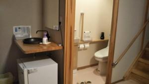 a small bathroom with a toilet and a sink at Nihonkai Nou no yado Miharashitei - Vacation STAY 11631 in Itoigawa