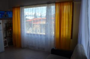 a window with curtains in a living room at TAID in Esquel