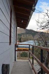 a porch of a house with a view of a lake at TAID in Esquel