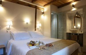 a bedroom with a bed with a tray of food on it at Au coeur du Village de Lucciana in Lucciana +27 photos