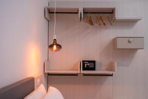 a room with a shelf and a light on the wall at Sorrento B&D Rooms in Sorrento