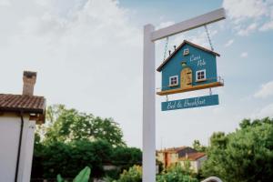 um sinal com uma casa azul num poste em Casa Polè em Bagnolo San Vito