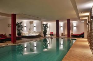 a hotel lobby with a pool and a spa at Wellnesshotel Schweizerhof in Saas-Fee
