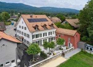an overhead view of a building with solar panels on its roofs at Auberge La Croix-Blanche in Gingins