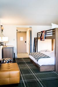 a bedroom with a bunk bed and a couch at Wildwood Snowmass in Snowmass Village