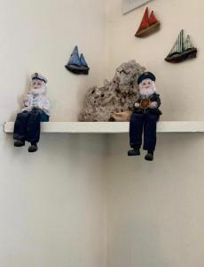 two dolls are sitting on a shelf with nautical items at Hosteria Puerto Palos in Puerto Pirámides
