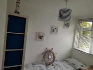 a room with a bed and a clock and a window at Sunrise 77 Sandown Bay Holiday Centre Generous Ferry Saving! in Sandown +4 photos