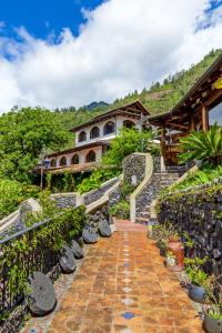 a house on a hill with a brick walkway at Samari Spa Resort in Baños