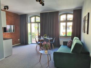 a living room with a couch and a table at Apartamenty K17 Centrum in Malbork