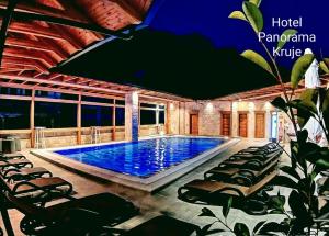 a swimming pool in a resort with lounge chairs at PANORAMA Rooms Hotel near the Old Bazaar in Krujë
