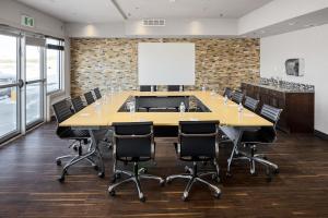 a large conference room with a large table and chairs at Home Inn & Suites - Swift Current in Swift Current