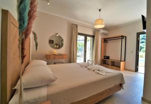 a bedroom with a bed and a large window at MERAVIGLIA in Parga