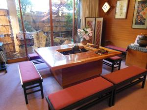 a kitchen with a sink in a room with chairs at Oyado Hayakawa in Toyooka