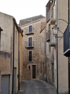 an alley in an old stone building with a street light at CASA a TORRE - GANGI CENTRO in Gangi