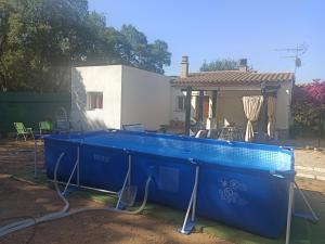 een blauw zwembad voor een huis bij Chalet en entorno Natural de la Costa Brava in Bell-Lloch