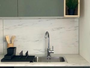 a kitchen counter with a sink and a sink at Apartment Anni in Pula