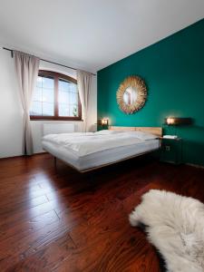 um quarto com uma cama grande e uma parede verde em TatryView Apartments by KingDubaj em Veľká Lomnica