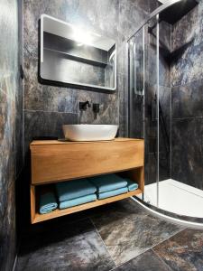 a bathroom with a sink and a shower at TatryView Apartments by KingDubaj in Veľká Lomnica