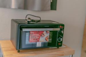 a green toaster oven sitting on a wooden shelf at Al Centro del Borgo in Guarene