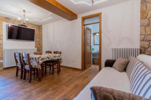 a living room with a table and a couch at Apartment Jurasić in Orlec