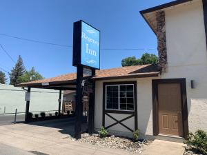 a sign in front of a building with a garage at Regency Inn Lakeport in Lakeport