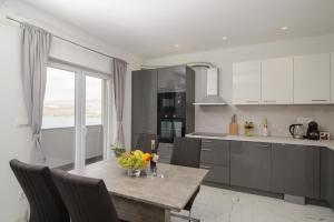 a kitchen with a table with a bowl of fruit on it at Apartments Pelja in Trogir