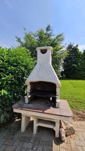 an outdoor oven sitting on a brick patio at Rehbrook in Süsel