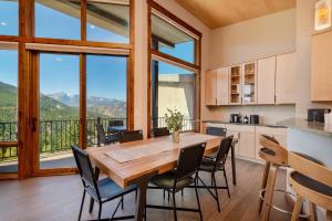 a kitchen and dining room with a table and chairs at Azure Vista Vacation Home at Windcliff home in Estes Park