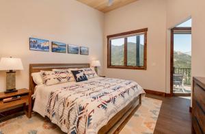 a bedroom with a bed and a window at Azure Vista Vacation Home at Windcliff home in Estes Park