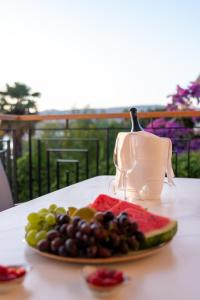 a plate of fruit on a table with a teapot at Luxury apartment Vagabundo 1 Free parking in Trogir
