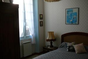 a bedroom with a bed and a window and a lamp at maison à 400 mètres de la plage in La Baule
