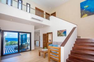 a staircase in a house with a view of the ocean at West Bay Breeze home in Roatan