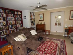 a living room with a couch and bookshelves at Werekataba in Mount Hutton