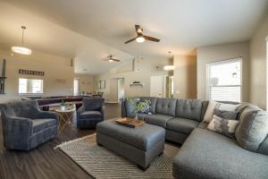 a living room with a gray couch and chairs at Glendale Keim home in Glendale