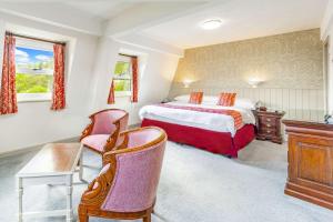 a bedroom with a bed and a desk and a chair at Best Western Limpley Stoke Hotel in Bath +57 photos