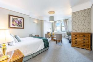 a hotel room with a large bed and a desk at Best Western Walton Park Hotel in Clevedon +71 photos