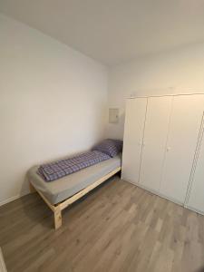 a small bedroom with a bed and cabinets in it at Sali Homes - 3BR Apartment with Kitchen in Kleve