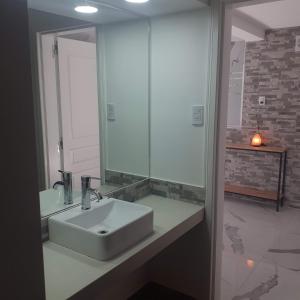 a bathroom with a sink and a mirror at Cabañas Tunita´s in Coronel Suárez