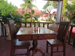 a chess game on a table with two chairs at Bonita Oasis Beach Resort in Moalboal
