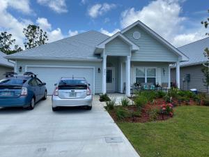 two cars parked in front of a house at Beach Room, for wonderful Vacation in Panama City Beach