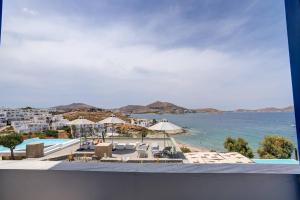 a view of the beach from the balcony of a resort at Paros Dream House #Naoussa Parodise in Naousa