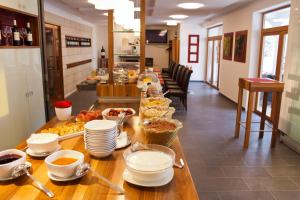 a long table with plates and bowls of food on it at Weingut Franz Schindler in Mörbisch am See
