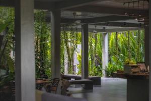 a patio with a bunch of trees and plants at Larimar Hotel & Resort in Phnom Penh