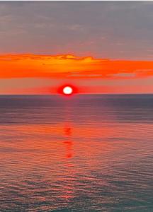 a sunset over the ocean with the sun reflecting in the water at Beach Room, for wonderful Vacation in Panama City Beach