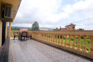 a balcony of a house with a table and chairs at Satyam Villa 5Bhk Lonavala in Lonavala