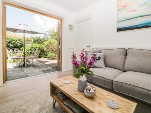 a living room with a couch and a table at 2 Garden Apartment in Kingsbridge